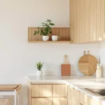 Warm-minimalist tiny apartment kitchen with light-wood cabinets, an open shelf, and a rolling cart.
